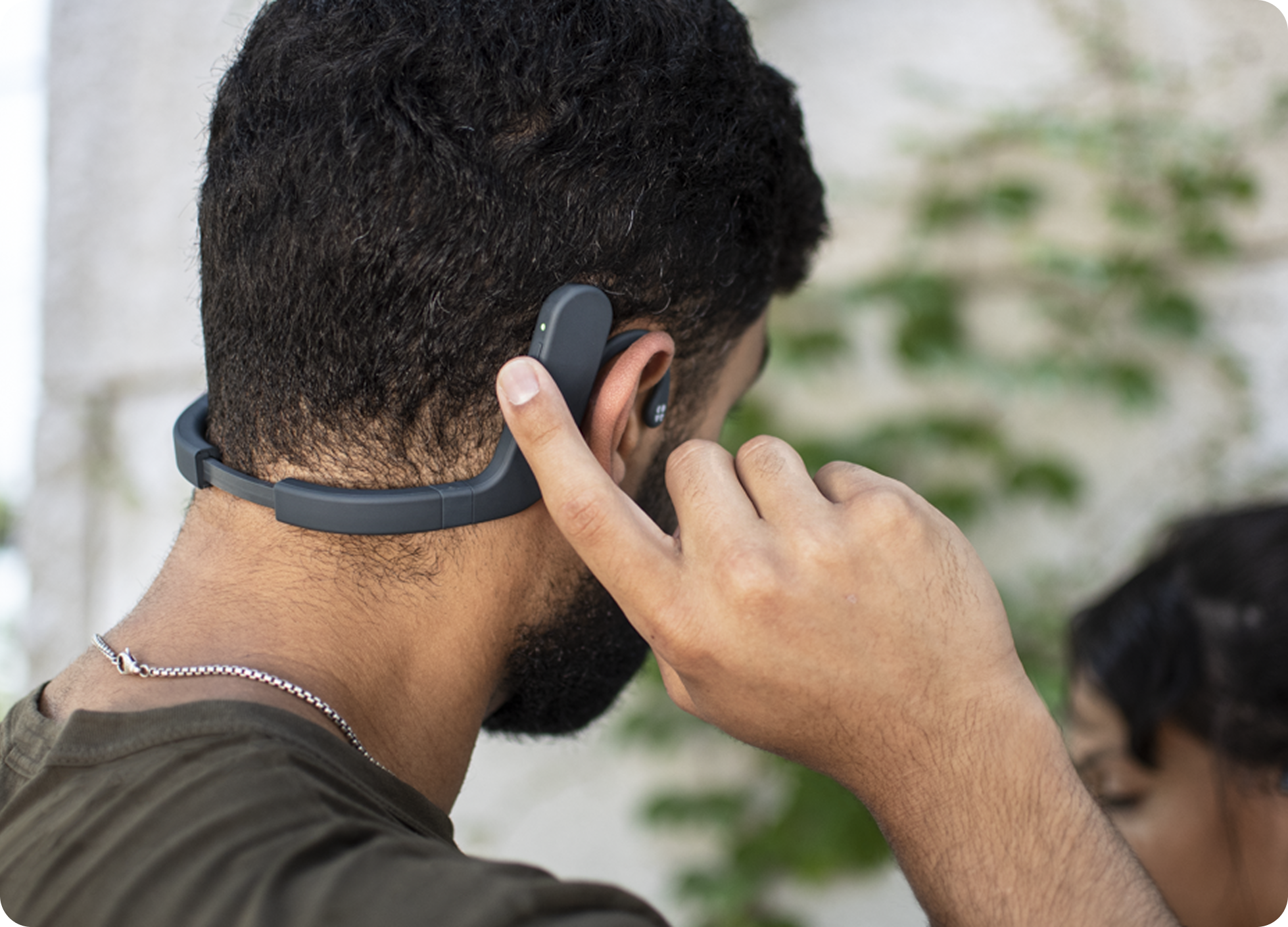 Person relaxing while using the Cove wearable device during a session